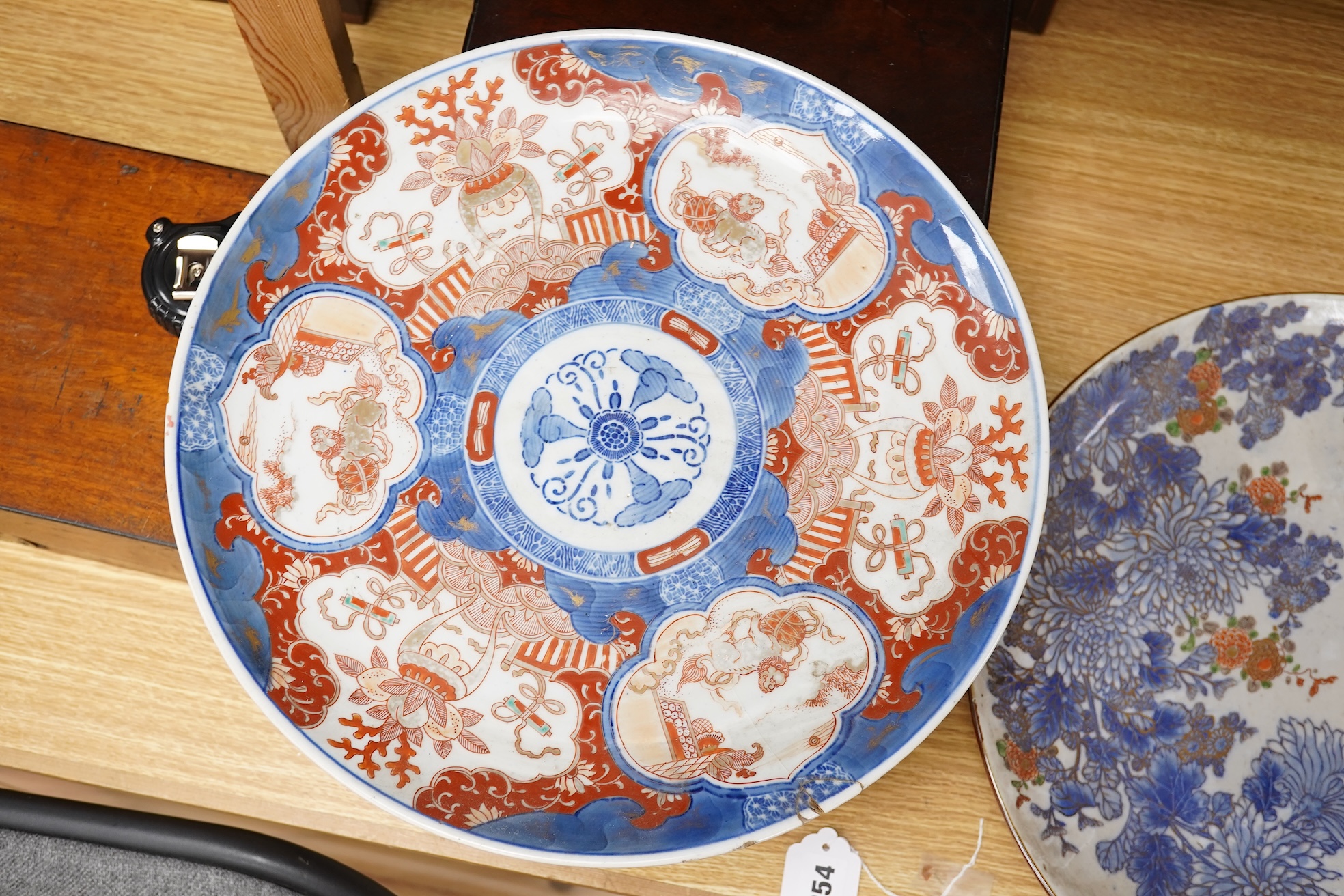 Three large Japanese dishes or chargers to include an Imari pattern example and one depicting Mount Fuji, largest 40cm in diameter